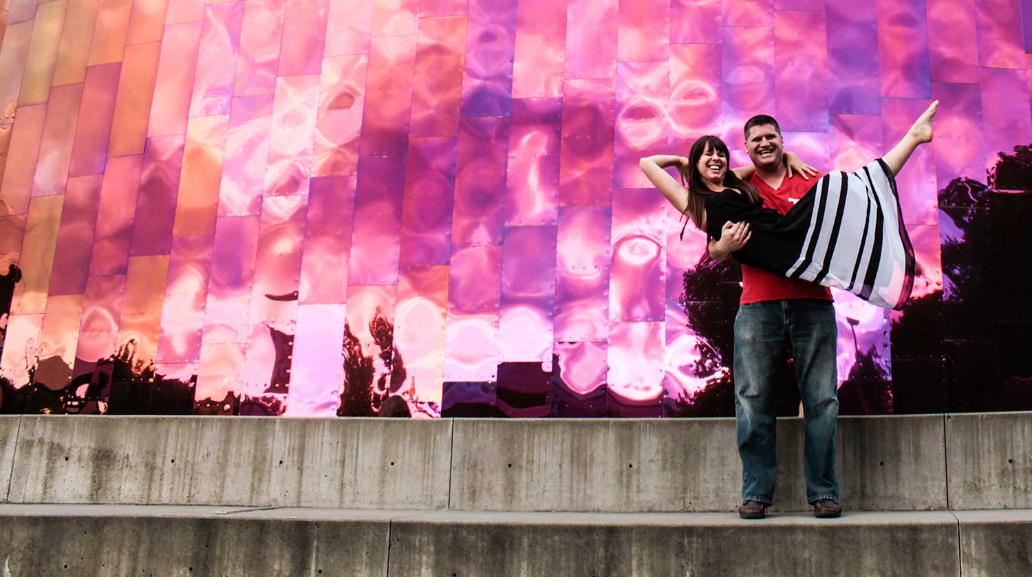 Karen and Greg posing in front of a museum in Seattle, Washington