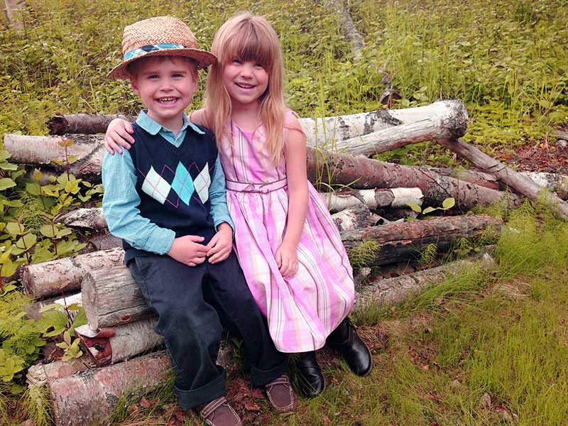 Matt and Rachel posing on logs in Alaska